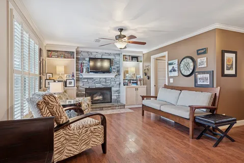 a living room with furniture a fireplace and a flat screen tv