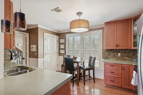 a kitchen with stainless steel appliances granite countertop a sink and a stove