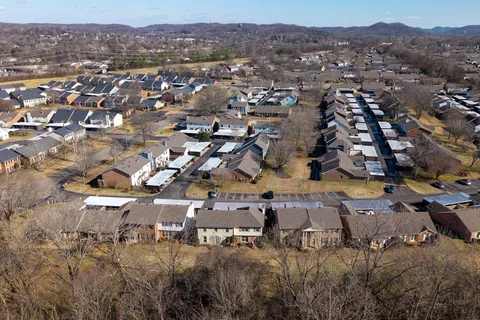 an aerial view of residential houses with outdoor space