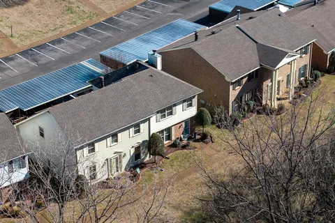 a aerial view of a house with a yard and balcony
