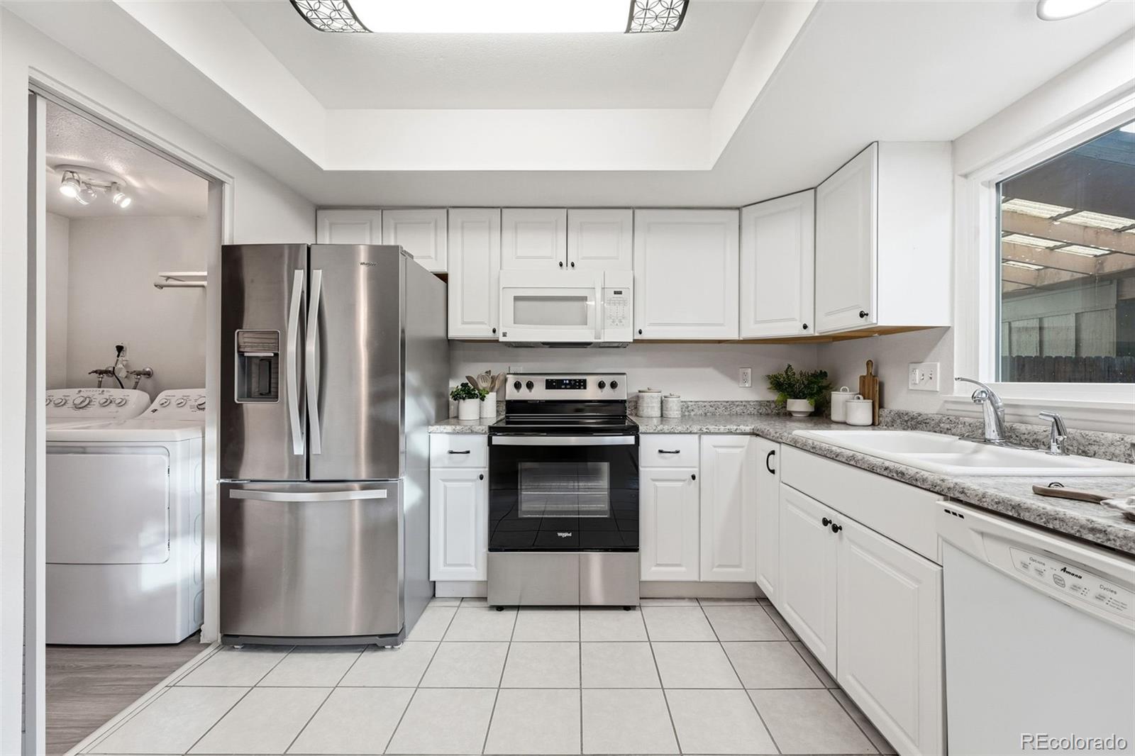 508 South Carr Street, Unit 118 Lakewood, CO 80226 - Photo 12 of 42 a kitchen with a refrigerator sink and cabinets