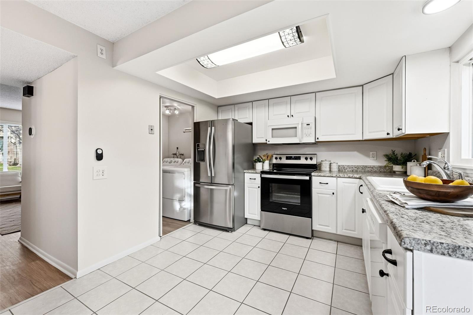 508 South Carr Street, Unit 118 Lakewood, CO 80226 - Photo 13 of 42 a kitchen with granite countertop a refrigerator oven a sink and cabinets