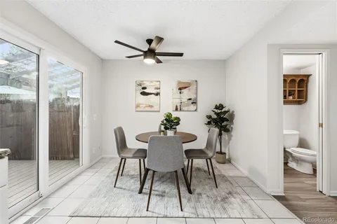 a view of a dining room with furniture and a potted plant