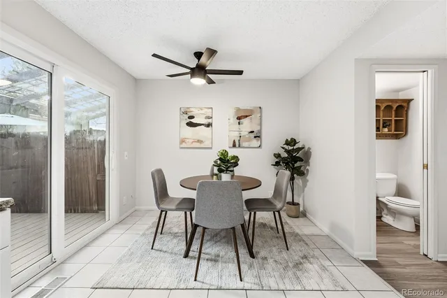 a view of a dining room with furniture and a potted plant