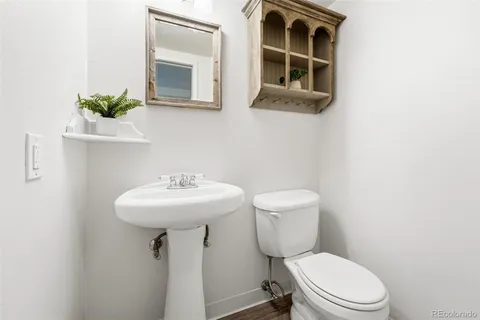a bathroom with a sink toilet and mirror