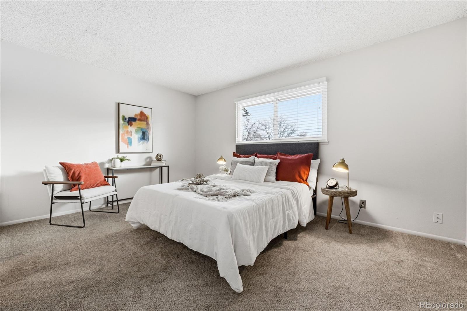 508 South Carr Street, Unit 118 Lakewood, CO 80226 - Photo 20 of 42 a bedroom with bed and a painting on the wall