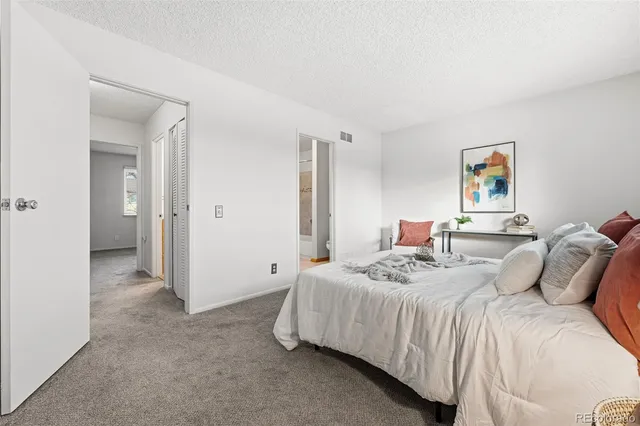 a bedroom with a bed and a painting