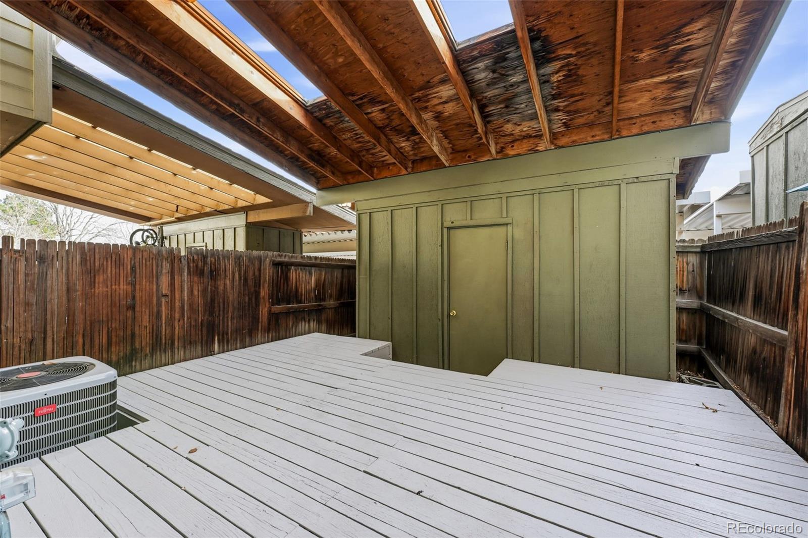 508 South Carr Street, Unit 118 Lakewood, CO 80226 - Photo 27 of 42 a bedroom with a bed and a chandelier