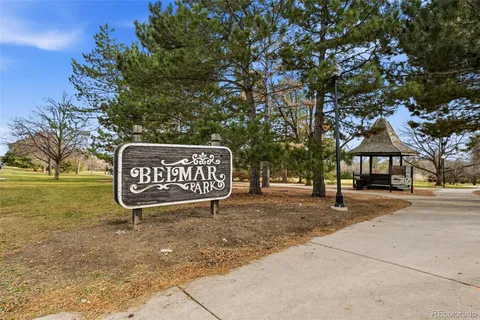 a sign board with parking space in back