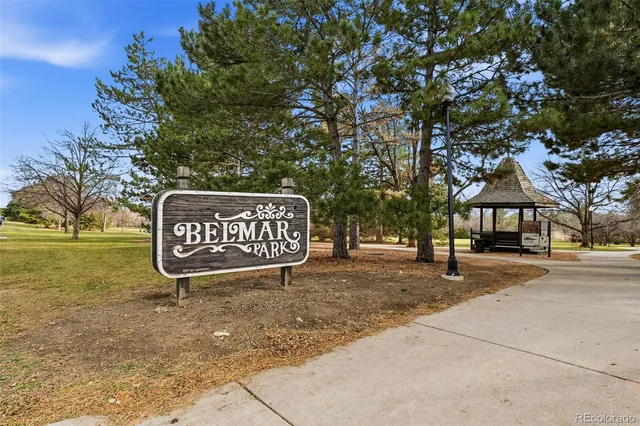 a sign board with parking space in back