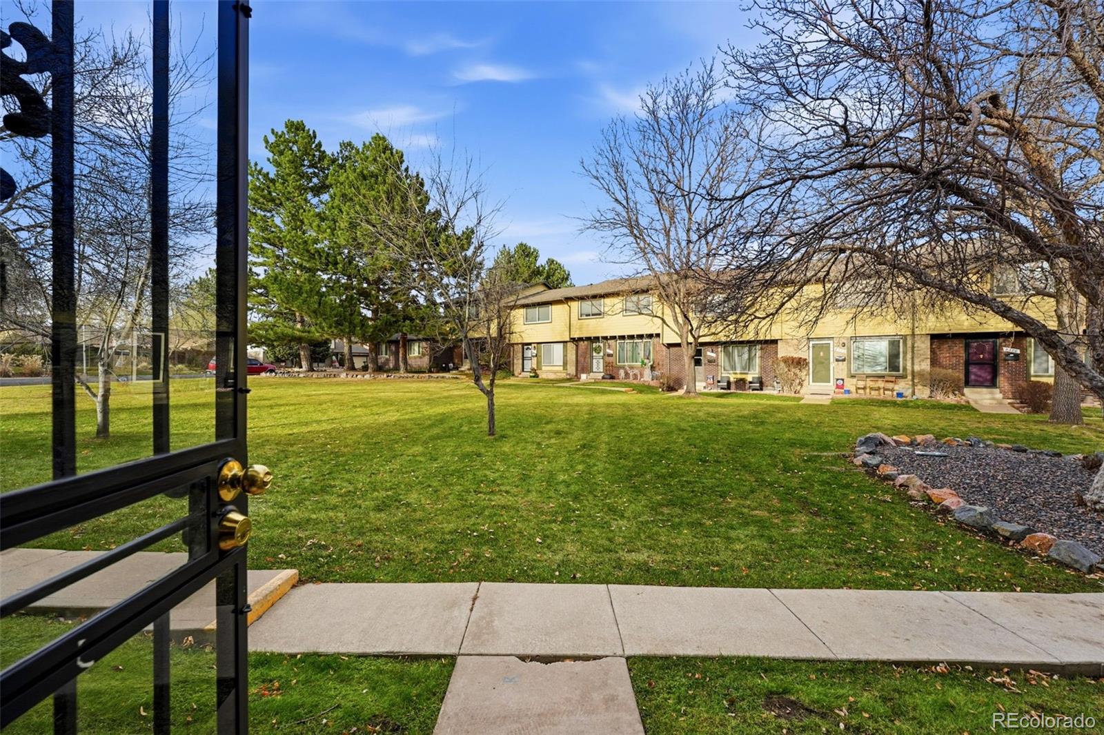 508 South Carr Street, Unit 118 Lakewood, CO 80226 - Photo 5 of 42 a front view of a house with a yard