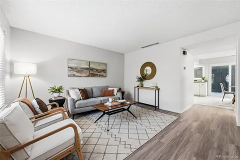 a living room with furniture a rug and a chandelier