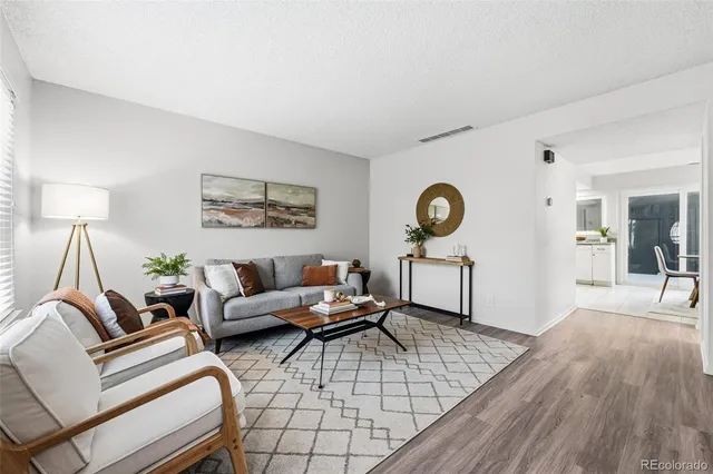 a living room with furniture a rug and a chandelier