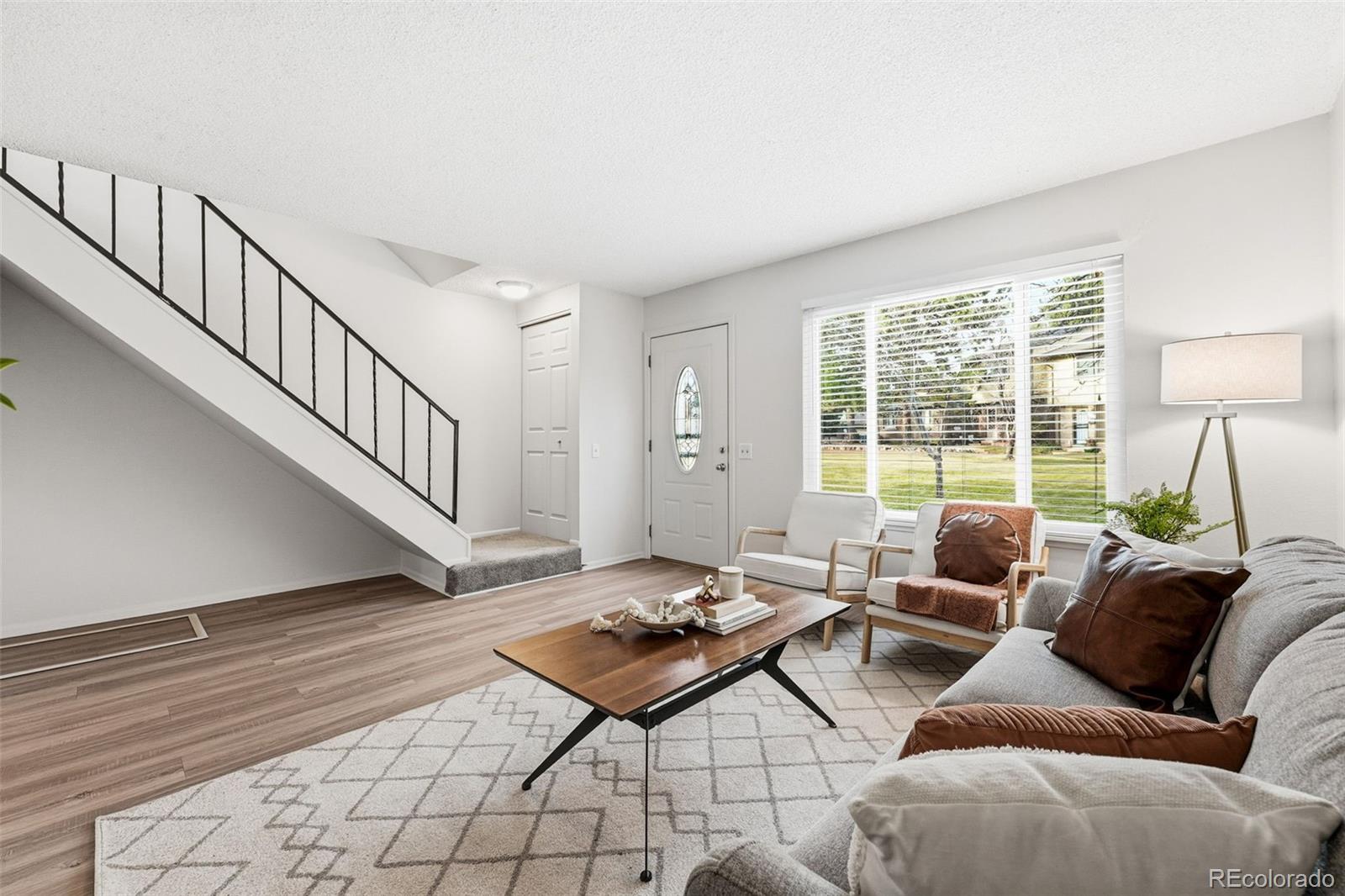 508 South Carr Street, Unit 118 Lakewood, CO 80226 - Photo 8 of 42 a living room with furniture and a table
