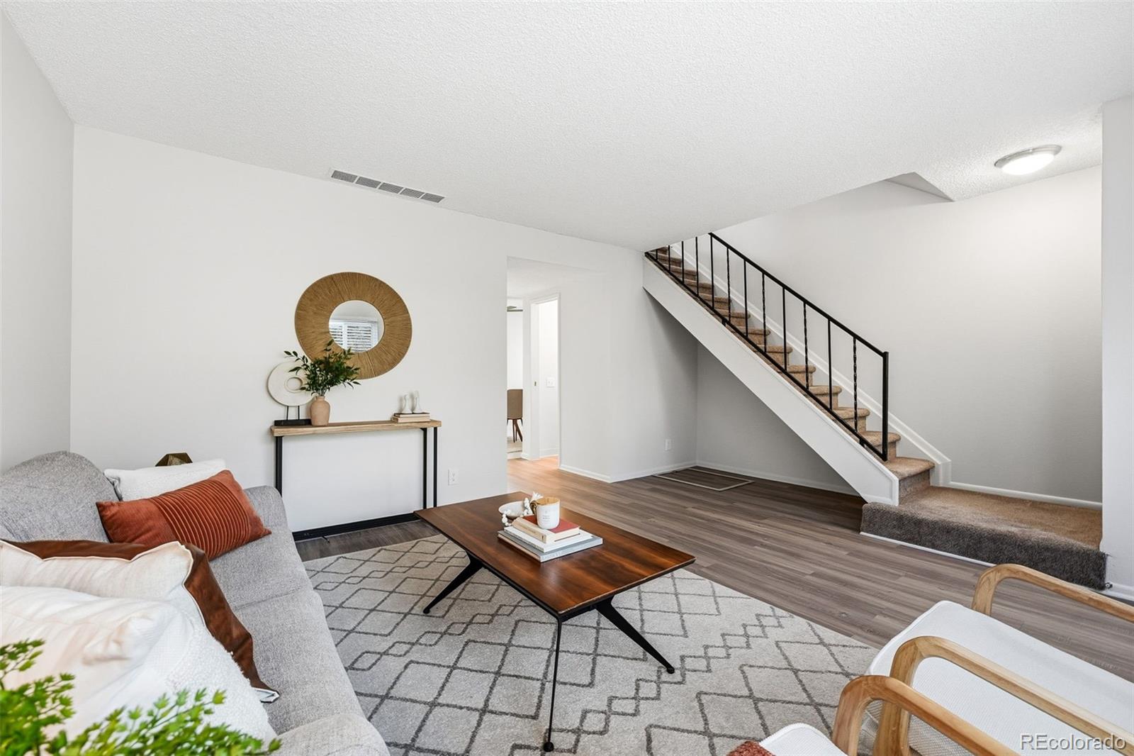 508 South Carr Street, Unit 118 Lakewood, CO 80226 - Photo 9 of 42 a living room with furniture and a wooden floor
