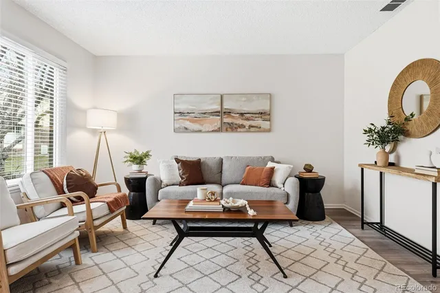 a living room with furniture and wooden floor