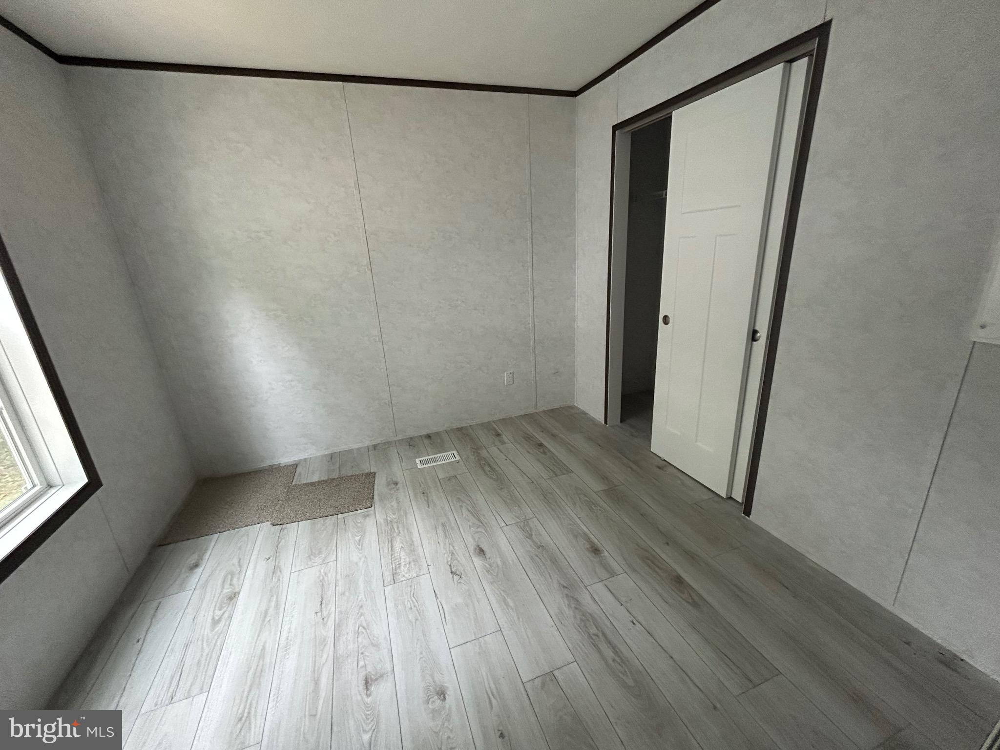 2501 Tilton Road, Unit 117 Egg Harbor Township, NJ 08234 - Photo 11 of 16 a view of a room with wooden floor and brick walls