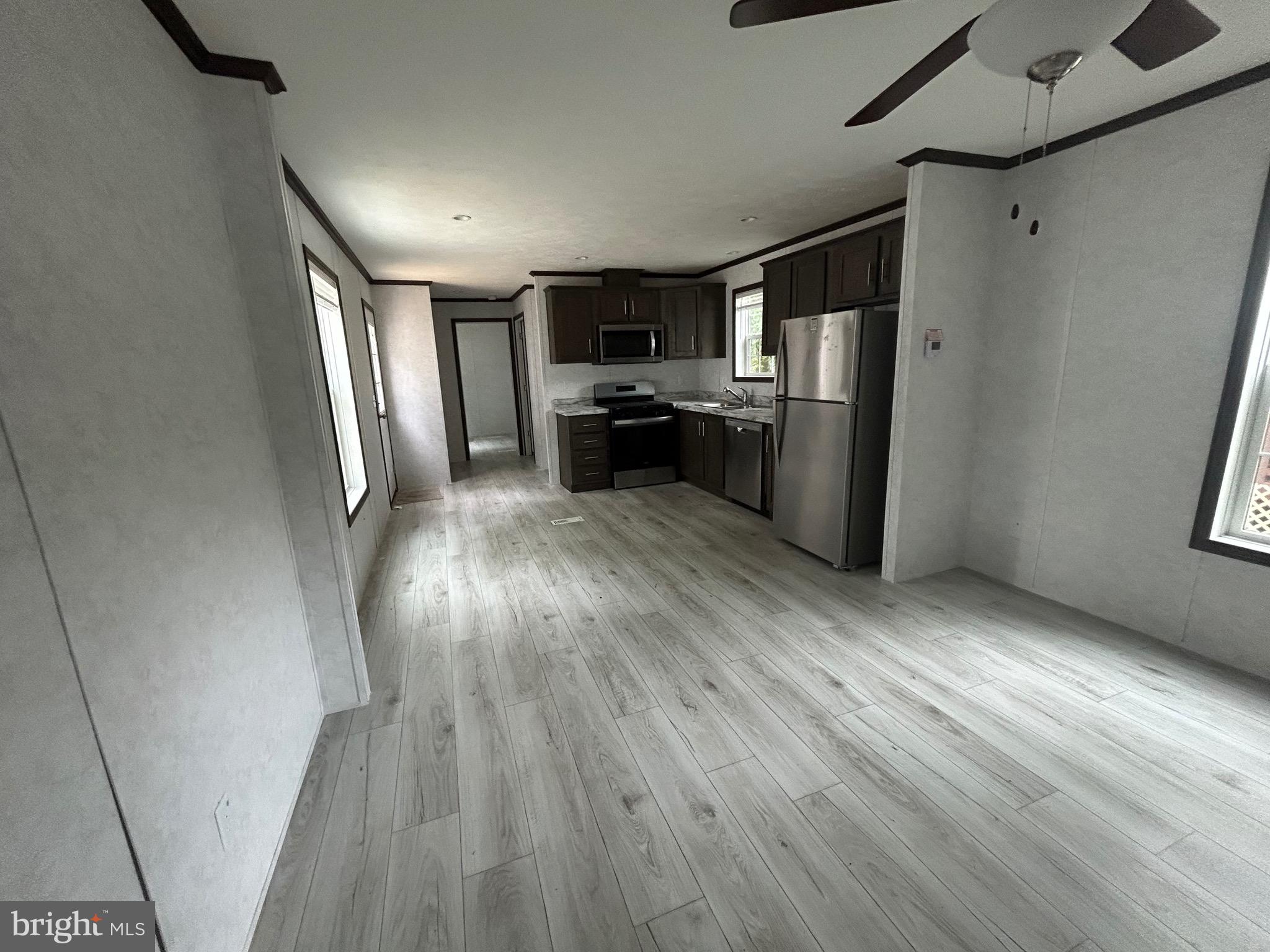 2501 Tilton Road, Unit 117 Egg Harbor Township, NJ 08234 - Photo 5 of 16 a view of kitchen with refrigerator stove and wooden floor