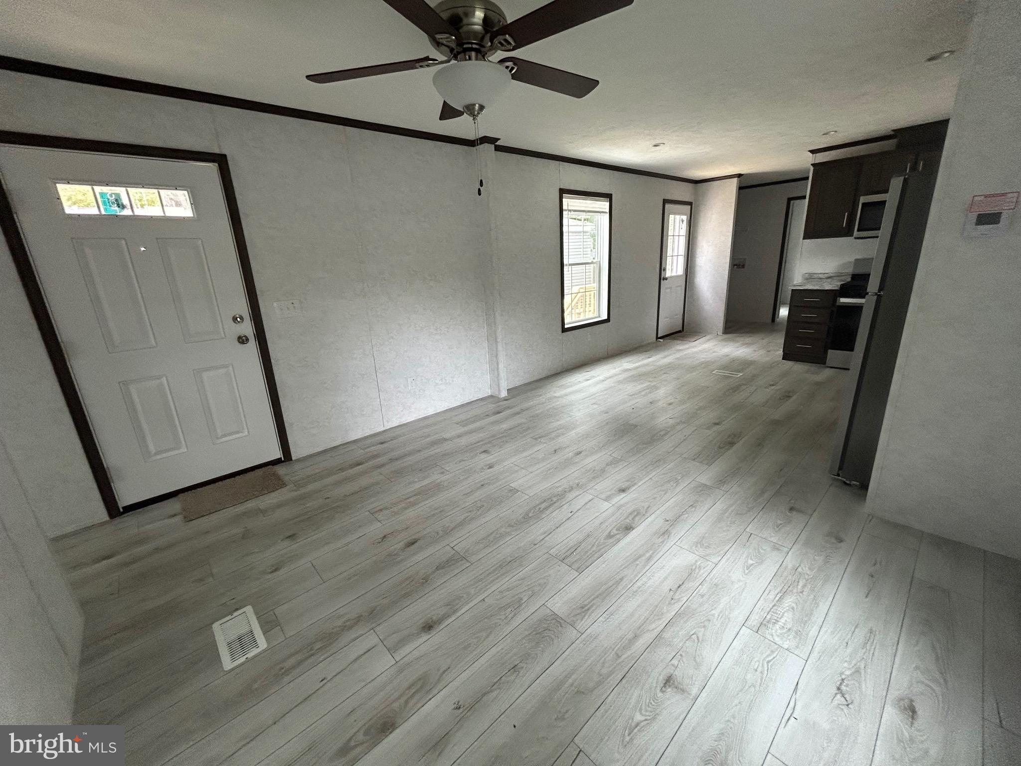 2501 Tilton Road, Unit 117 Egg Harbor Township, NJ 08234 - Photo 9 of 16 a view of livingroom with hardwood floor and hallway