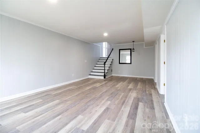 a view of a room with wooden floor and stairs