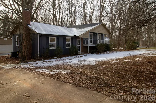 a view of a house with a yard covered in snow