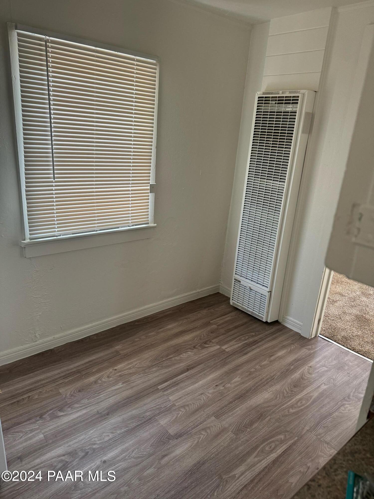 818 West Rosser Street Prescott, AZ 86301 - Photo 3 of 7 an empty room with wooden floor and windows