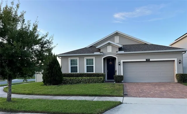 a front view of a house with a yard and garage