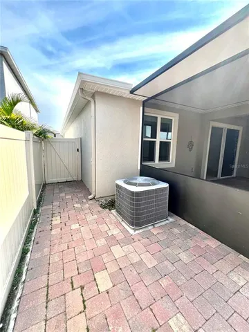 a backyard of a house with table and chairs