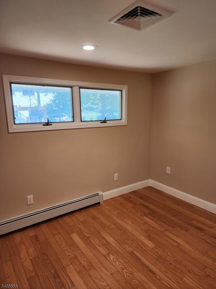 23 Old Farm Road Berkeley Heights, NJ 07922 - Photo 14 of 28 an empty room with wooden floor and windows