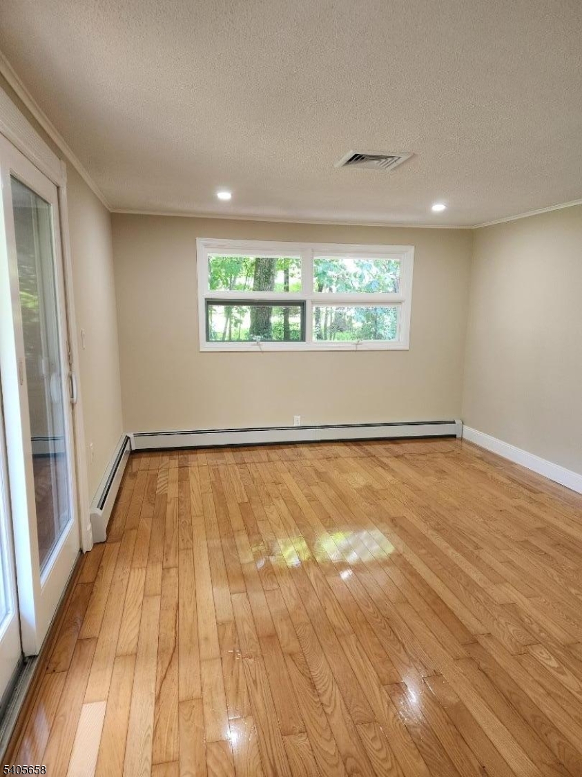 23 Old Farm Road Berkeley Heights, NJ 07922 - Photo 15 of 28 wooden floor in an empty room with a window