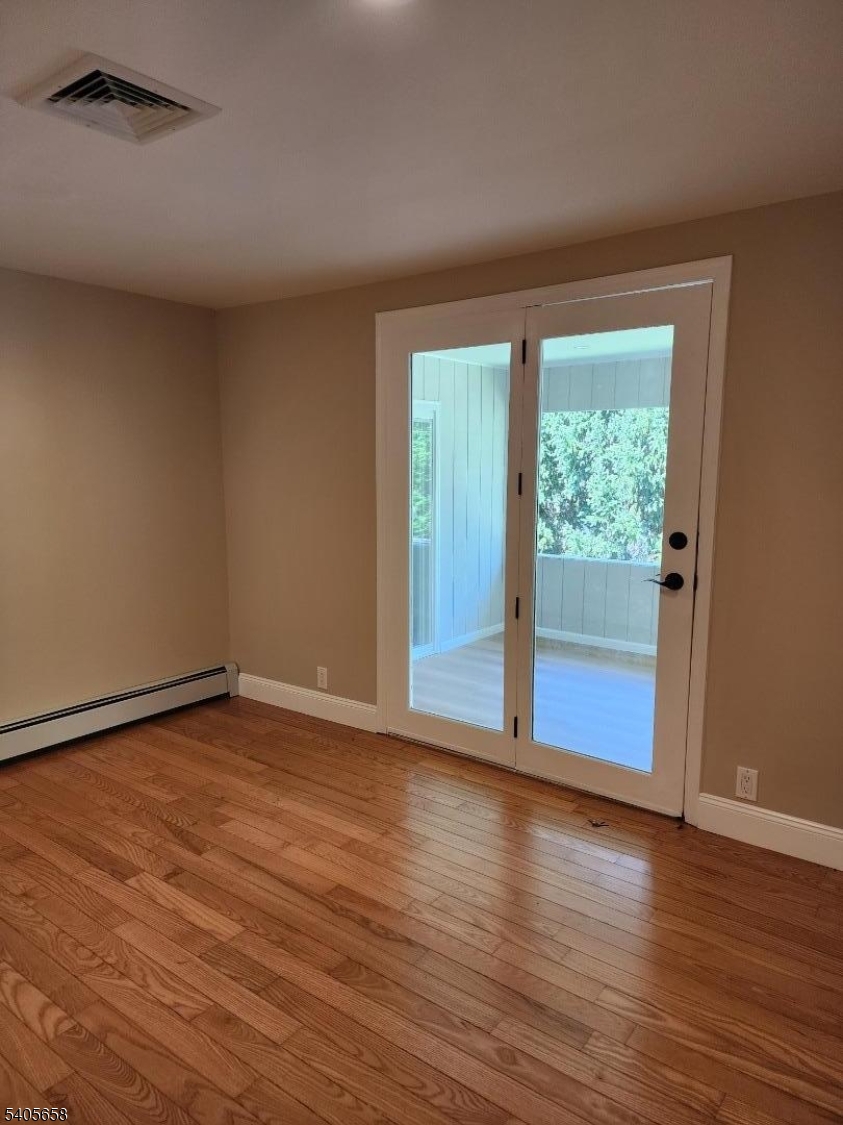 23 Old Farm Road Berkeley Heights, NJ 07922 - Photo 17 of 28 a view of an empty room with wooden floor and a window