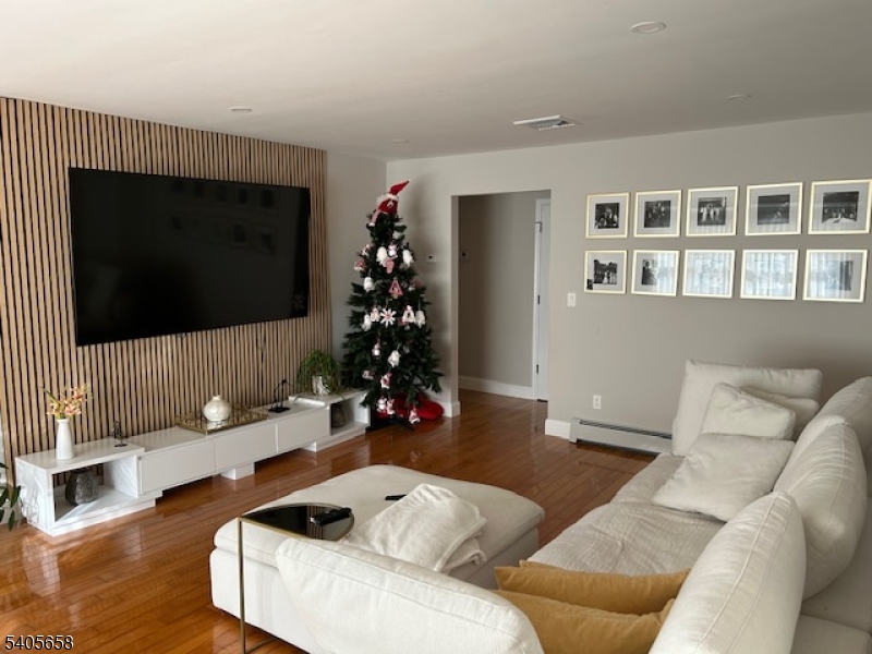 23 Old Farm Road Berkeley Heights, NJ 07922 - Photo 25 of 28 a living room with furniture and a flat screen tv