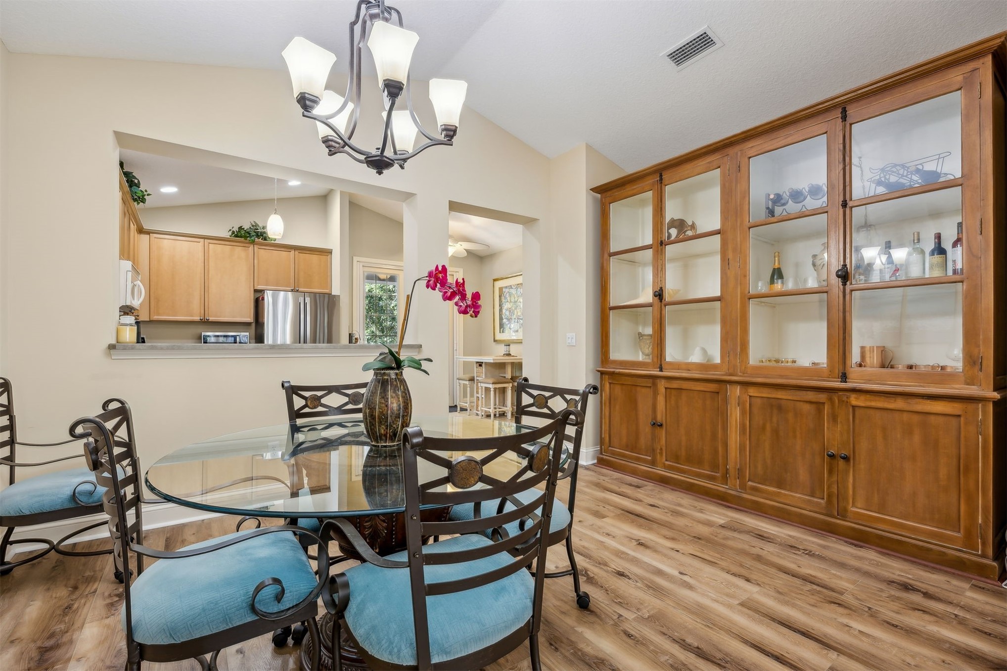 1839 Perimeter Park Road West, Unit 210 Fernandina Beach, FL 32034 - Photo 8 of 37 a view of a dining room with furniture a chandelier and wooden floor
