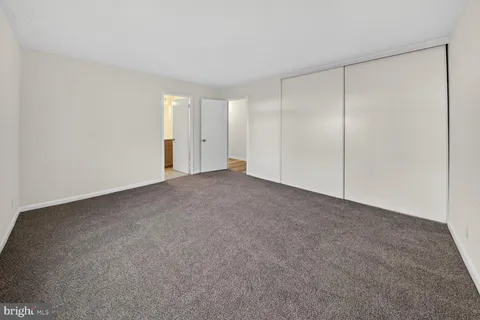 a view of an empty room and closet area