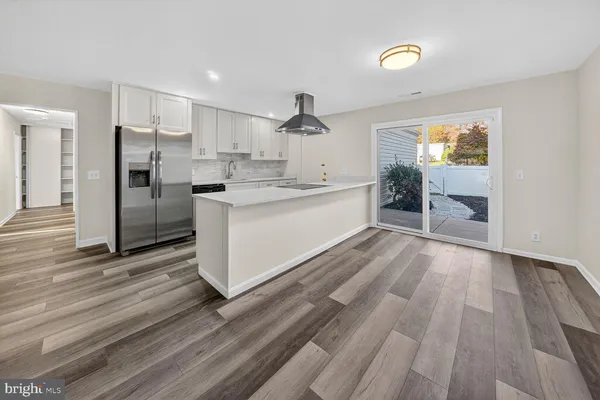 a large kitchen with a lot of counter space and stainless steel appliances