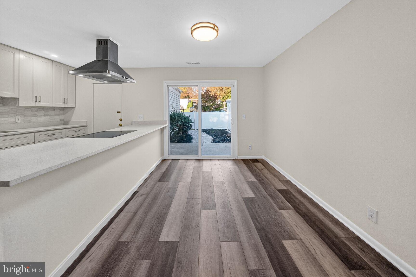 14507 Elmhan Court, Unit 182B Silver Spring, MD 20906 - Photo 8 of 21 wooden floor in an empty room with a window