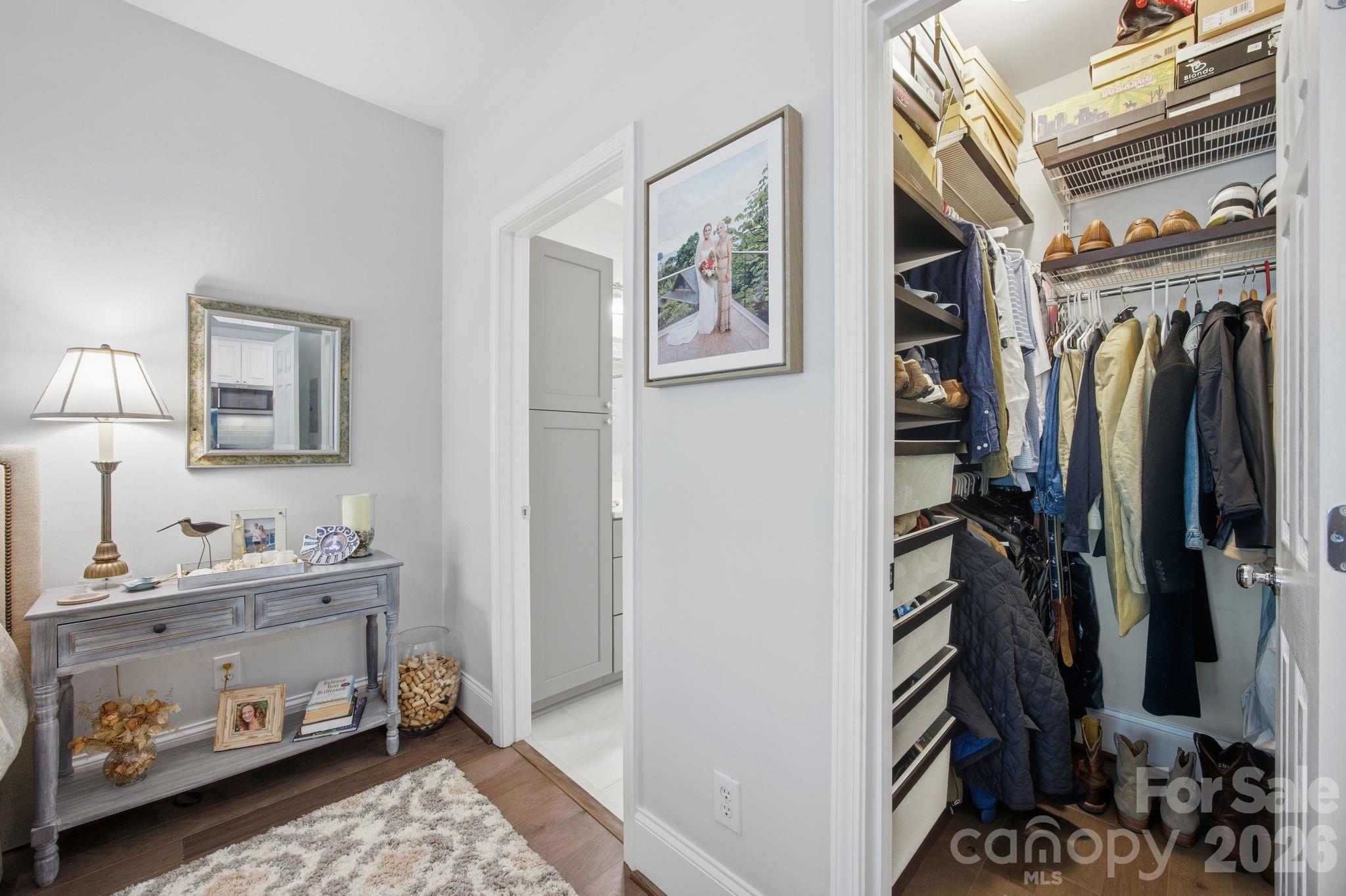 8942 Rosalyn Glen Road Cornelius, NC 28031 - Photo 27 of 47 a view of walk in closet with clothes and shoes