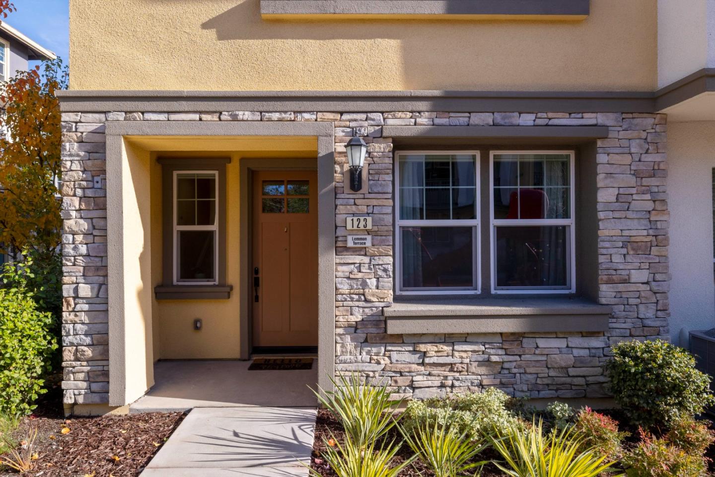 123 Lemmon Terrace Sunnyvale, CA 94086 - Photo 2 of 42 a front view of a building with a garden