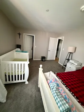 a bedroom with a bed and a mirror