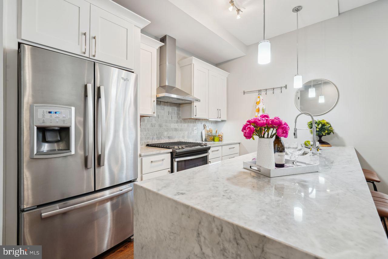 1401 K Street Southeast, Unit 1 Washington, DC 20003 - Photo 14 of 48 a kitchen with stainless steel appliances granite countertop a refrigerator a stove and a sink