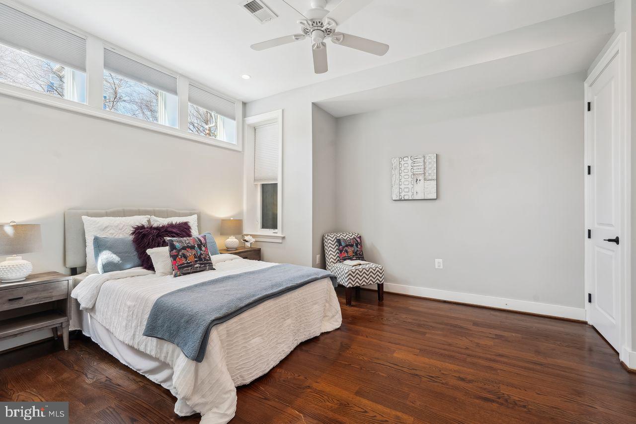 1401 K Street Southeast, Unit 1 Washington, DC 20003 - Photo 24 of 48 a bed room with a bed and a chandelier