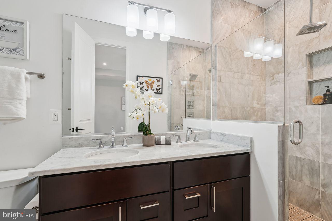 1401 K Street Southeast, Unit 1 Washington, DC 20003 - Photo 27 of 48 a bathroom with a sink double vanity and a mirror