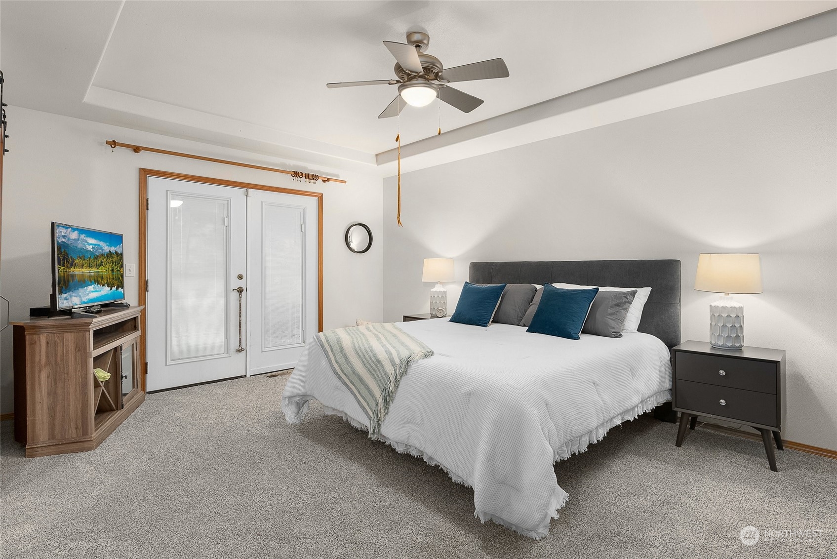 17310 Freestad Road Arlington, WA 98223 - Photo 18 of 29 a spacious bedroom with a bed and a chandelier