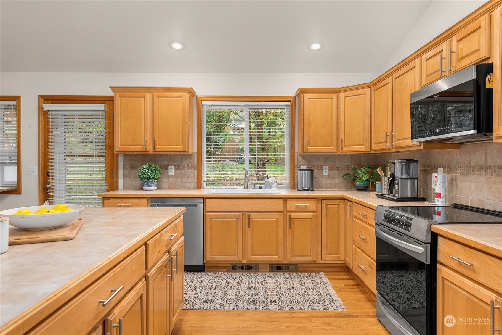 17310 Freestad Road Arlington, WA 98223 - Photo 6 of 29 a kitchen with stainless steel appliances granite countertop a stove a sink and a microwave