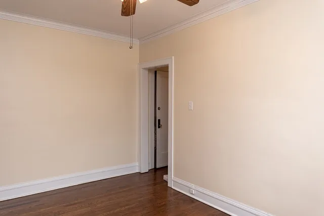 a view of a small space with wooden floor and a window