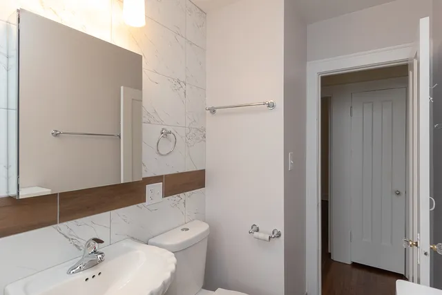 a bathroom with a toilet a sink and shower