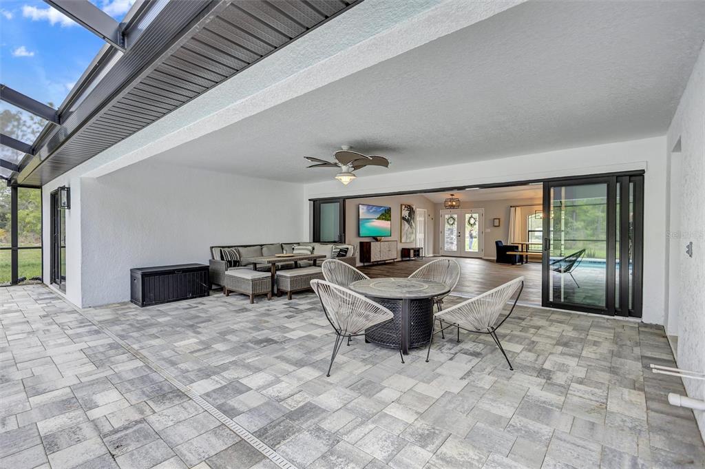 13362 Downy Woodpecker Road Weeki Wachee, FL 34614 - Photo 21 of 26 a living room with patio furniture and a fireplace