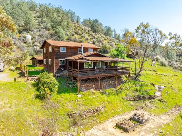 a view of a livingroom with wooden floor and furniture
