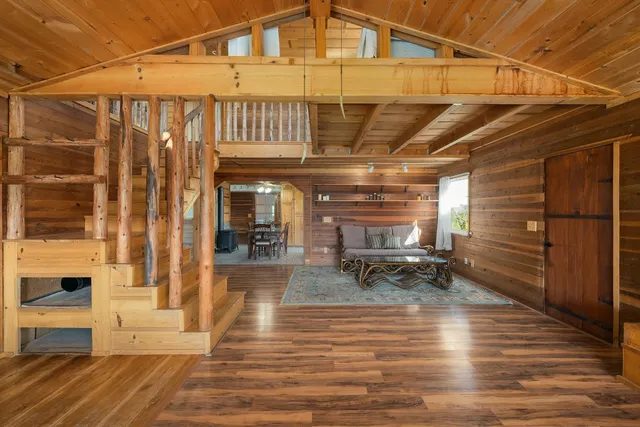 a dining hall with stainless steel appliances a table and chairs