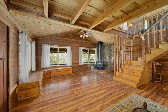 a utility room with stainless steel appliances a sink window and cabinets
